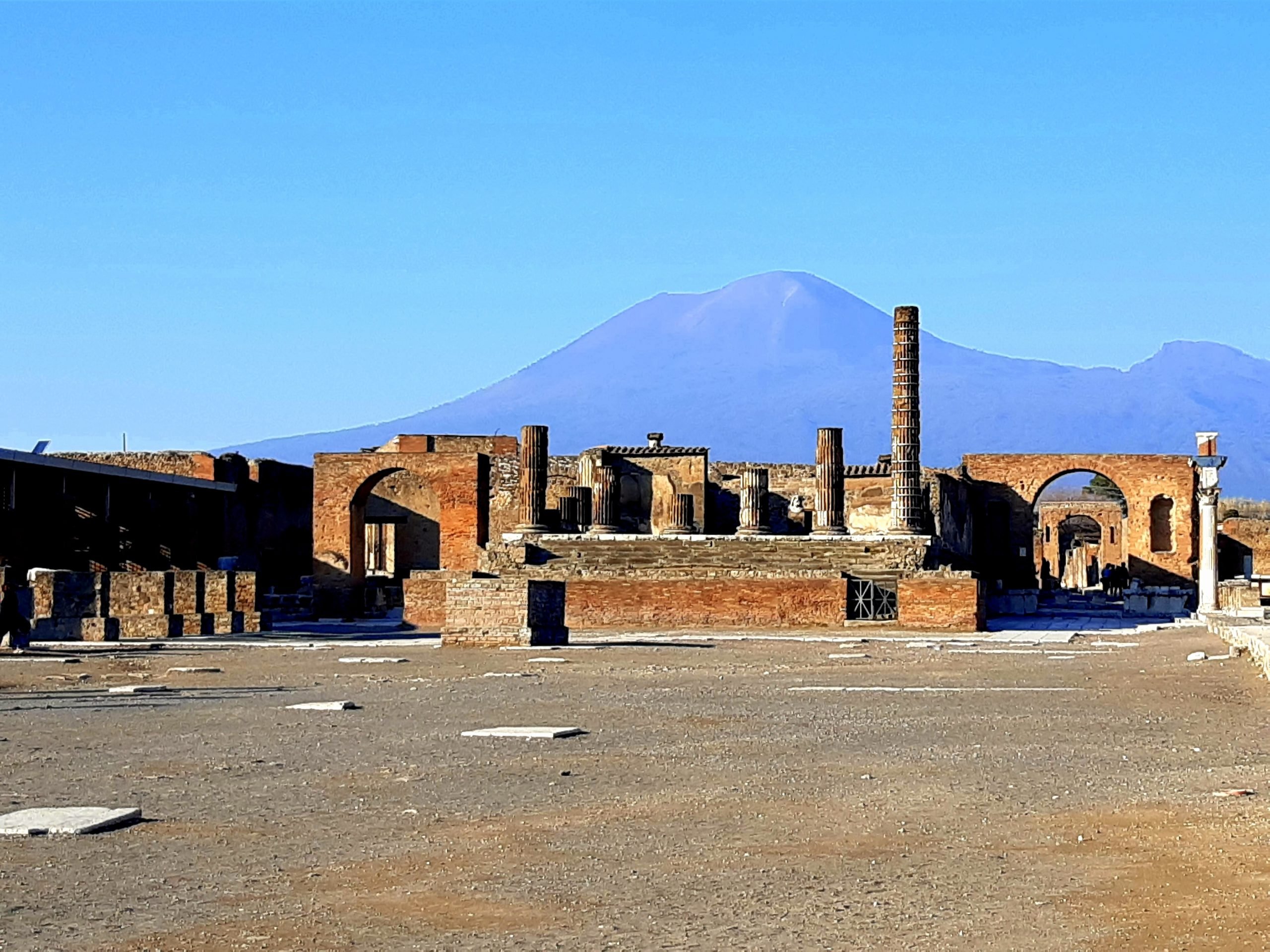 ruins of city of pompeii, naples with mount vesuvius in the background